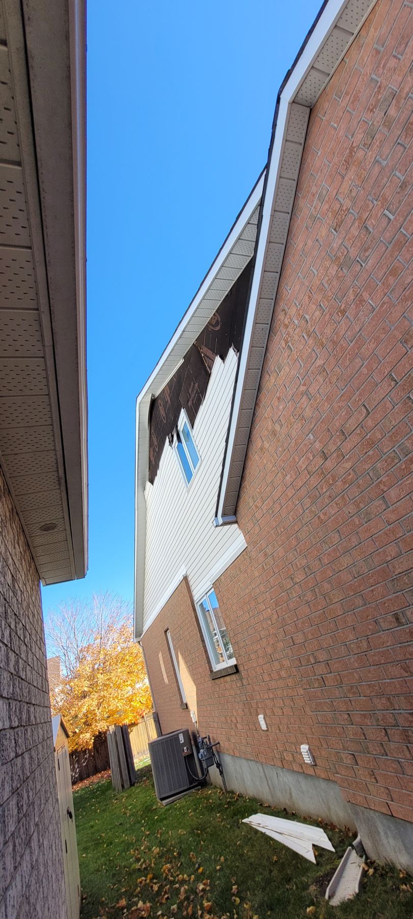 New soffit and fascia along the roofline of a brick home